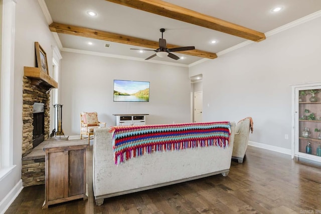 bedroom featuring baseboards, beam ceiling, a fireplace, dark wood-type flooring, and crown molding