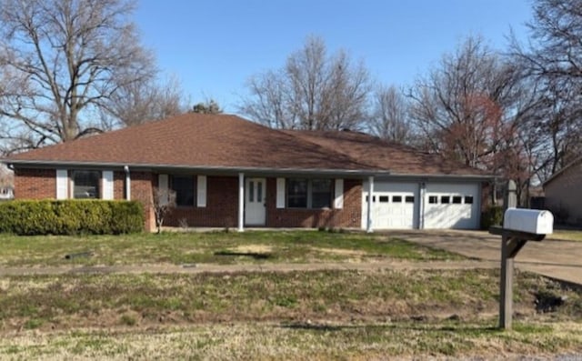 single story home with concrete driveway, an attached garage, brick siding, and a front lawn