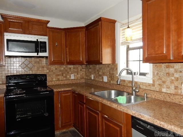 kitchen featuring dishwasher, decorative backsplash, black electric range oven, and a sink