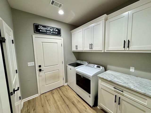 clothes washing area featuring visible vents, recessed lighting, cabinet space, separate washer and dryer, and light wood finished floors