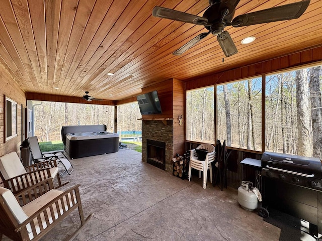 interior space featuring a wealth of natural light, ceiling fan, and wooden ceiling