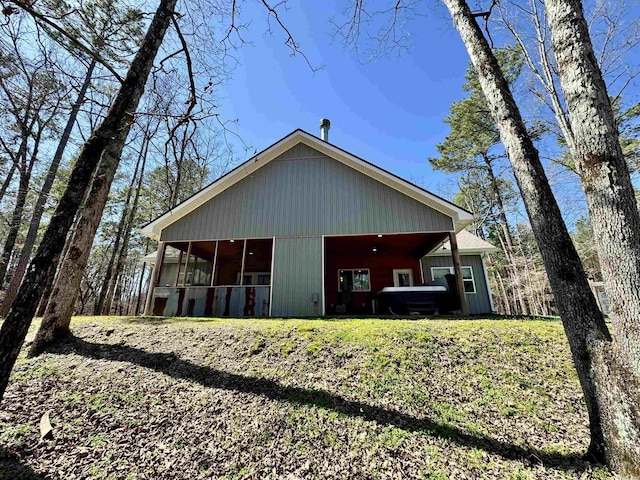 back of property with a sunroom