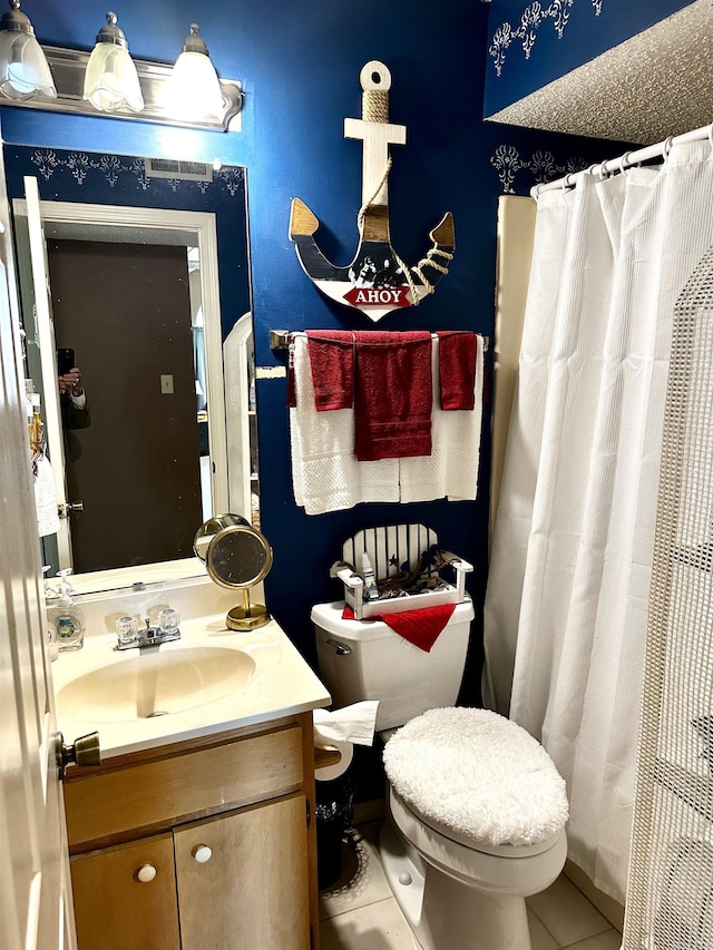 full bathroom featuring vanity, tile patterned floors, curtained shower, and toilet