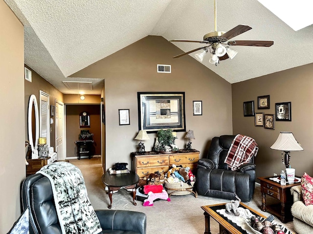 carpeted living area with visible vents, a textured ceiling, lofted ceiling, attic access, and ceiling fan