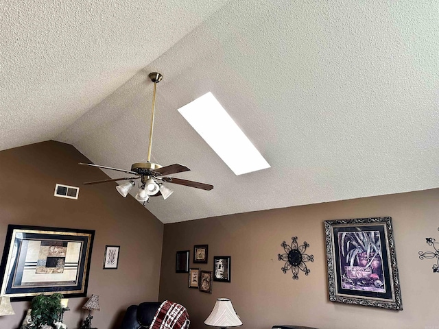 interior details featuring visible vents, a textured ceiling, a skylight, and a ceiling fan