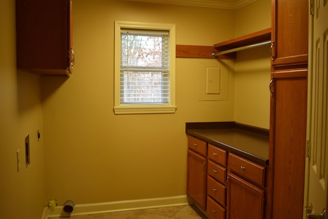 laundry room featuring electric panel, cabinet space, baseboards, and hookup for an electric dryer