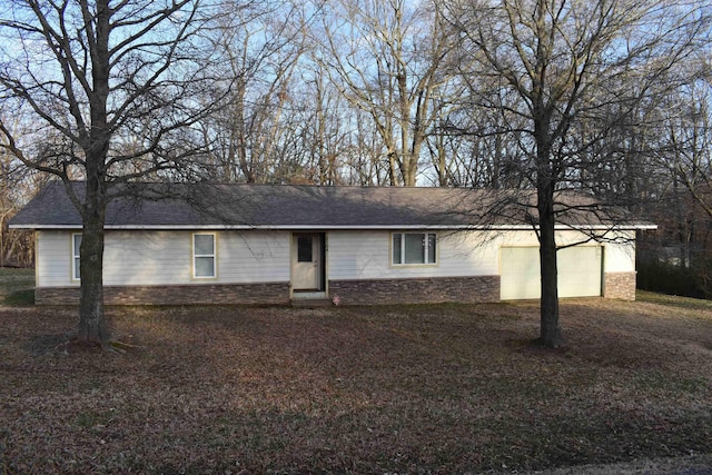 single story home featuring stone siding, driveway, a shingled roof, and a garage