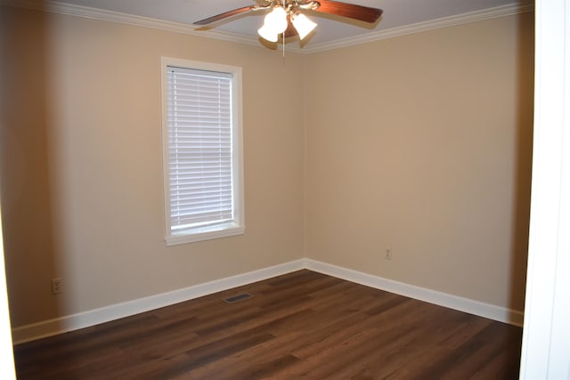 spare room with visible vents, baseboards, dark wood finished floors, and crown molding