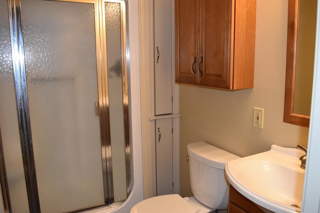 full bathroom featuring vanity, a shower stall, and toilet