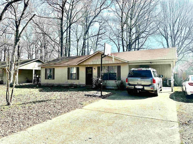 ranch-style home with an attached garage, driveway, and a chimney