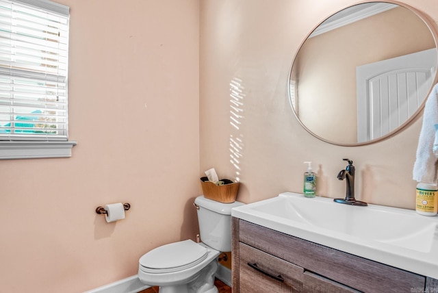 bathroom with vanity, toilet, and baseboards