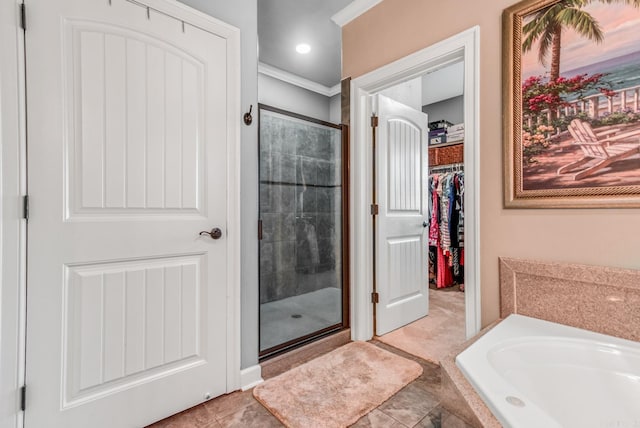 full bath featuring a walk in closet, a stall shower, crown molding, and a bath