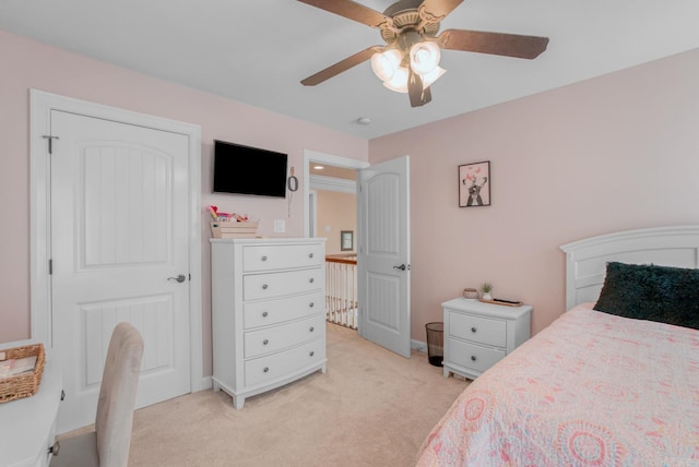 bedroom with baseboards, light carpet, and a ceiling fan