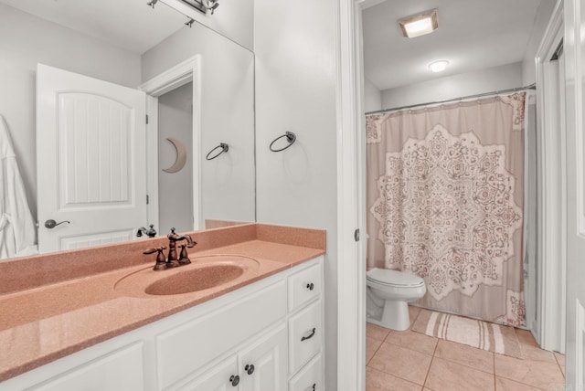 bathroom featuring vanity, tile patterned floors, and toilet