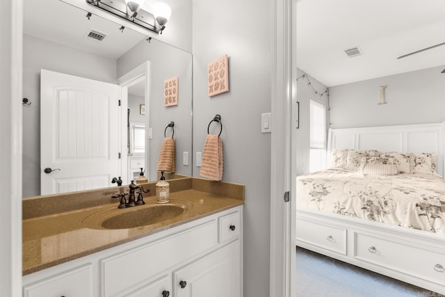 bathroom with vanity, visible vents, and a wealth of natural light