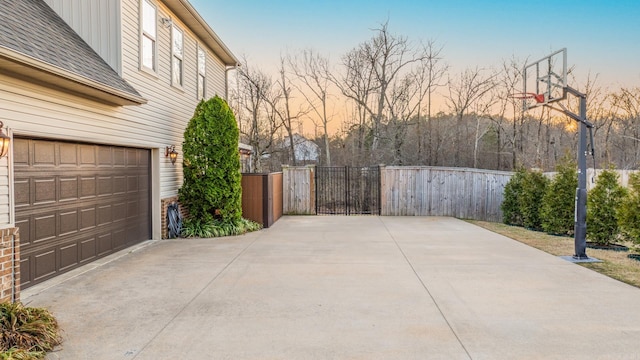 exterior space with fence, a garage, and a gate