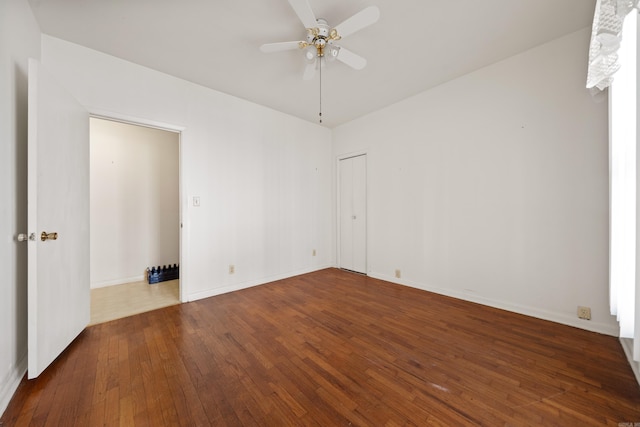 unfurnished room featuring baseboards, a ceiling fan, and hardwood / wood-style flooring