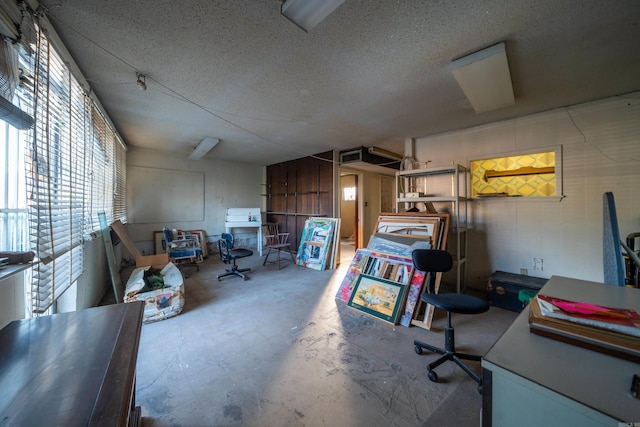 interior space with unfinished concrete flooring and a textured ceiling