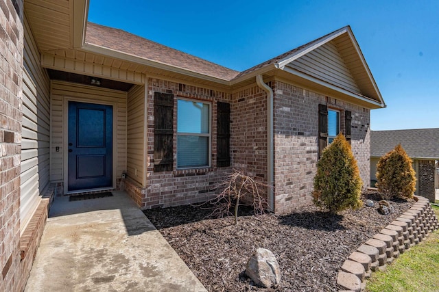 property entrance with brick siding