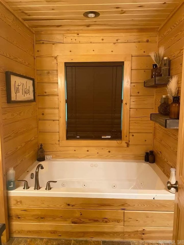 full bathroom with wooden ceiling, wooden walls, and a tub with jets