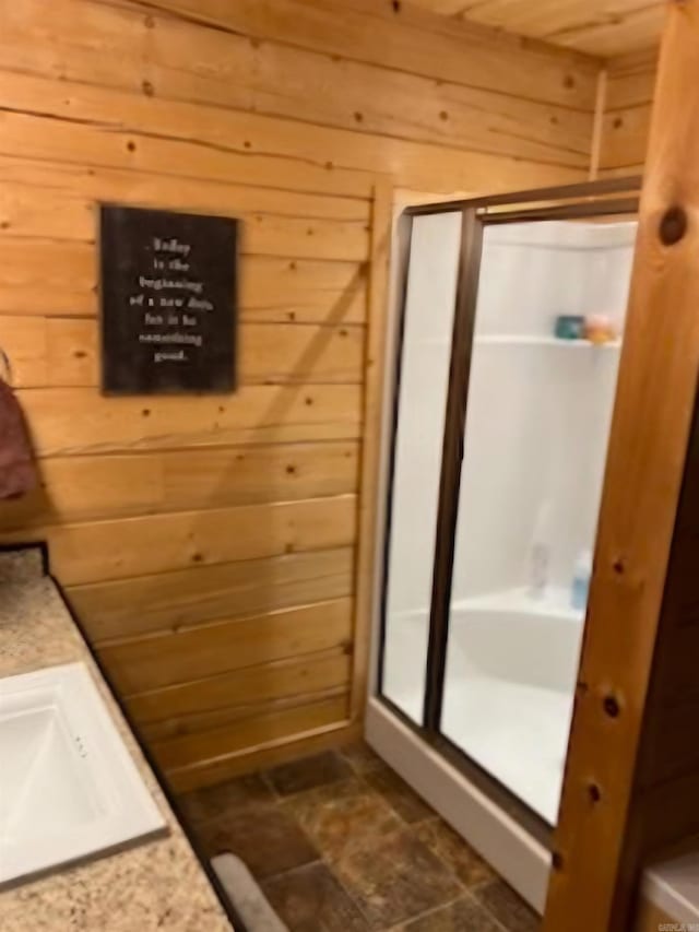 bathroom featuring a shower stall and wood walls