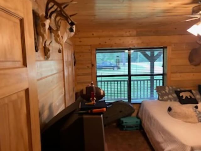 bedroom featuring wooden walls and wood ceiling