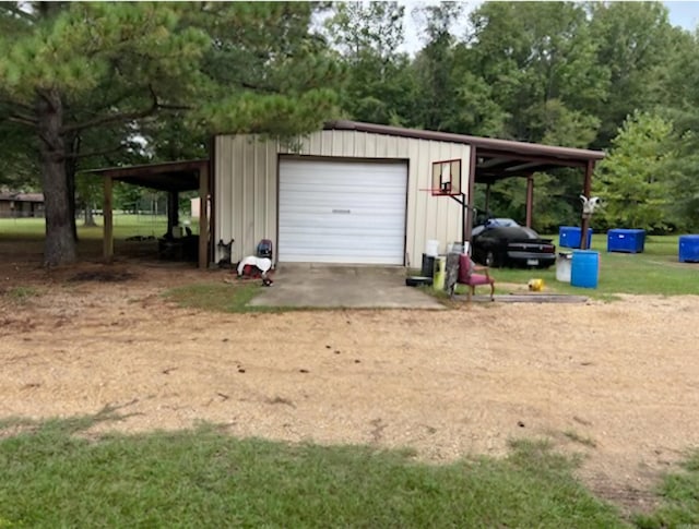 garage featuring a detached garage and driveway