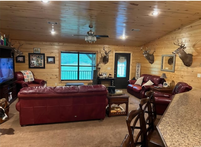 living room with wooden walls, ceiling fan, wood ceiling, lofted ceiling, and carpet flooring