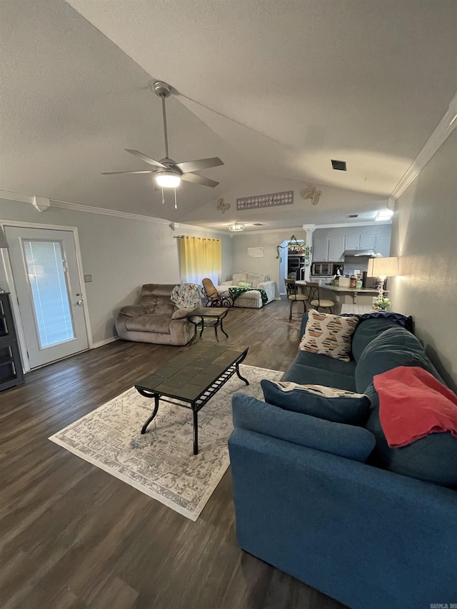 living area featuring a textured ceiling, crown molding, and wood finished floors