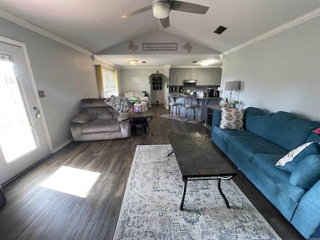 living room with baseboards, dark wood-style flooring, ceiling fan, ornamental molding, and vaulted ceiling