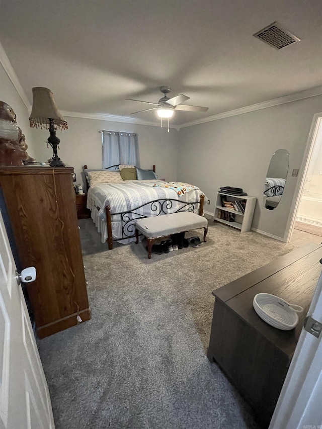 carpeted bedroom featuring visible vents, a ceiling fan, and crown molding