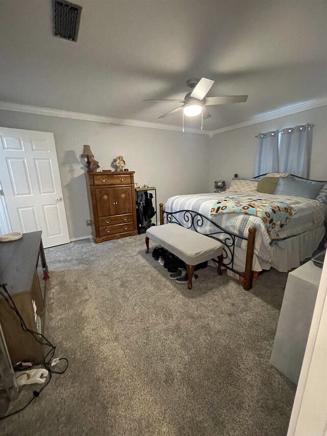 carpeted bedroom featuring visible vents, ceiling fan, and crown molding