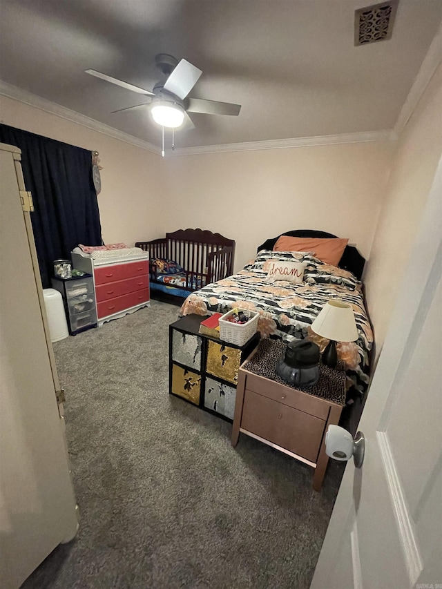 carpeted bedroom featuring visible vents, crown molding, and ceiling fan