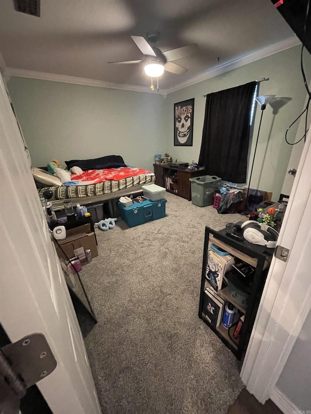 carpeted bedroom with visible vents, ceiling fan, and crown molding