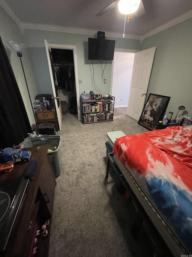 bedroom featuring ceiling fan, ornamental molding, and carpet flooring