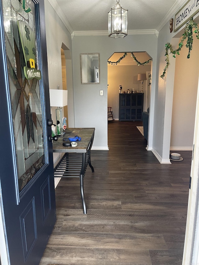 office space featuring arched walkways, crown molding, and wood finished floors