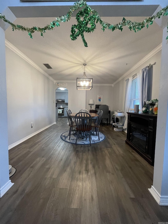 dining room with visible vents, arched walkways, dark wood-type flooring, and crown molding