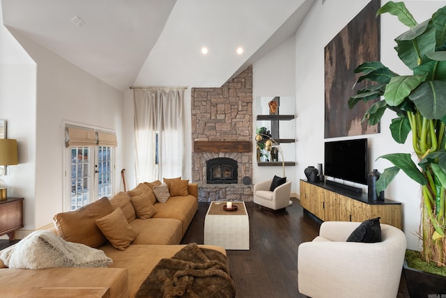 living room featuring high vaulted ceiling, wood finished floors, and a fireplace