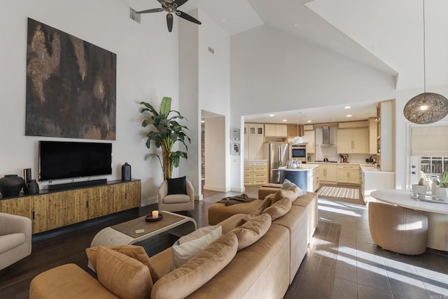 living area featuring recessed lighting, visible vents, high vaulted ceiling, and ceiling fan