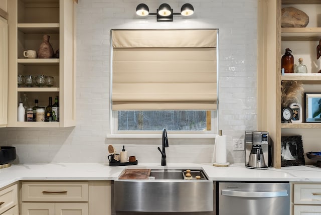 kitchen with light stone counters, white cabinetry, a sink, dishwasher, and backsplash