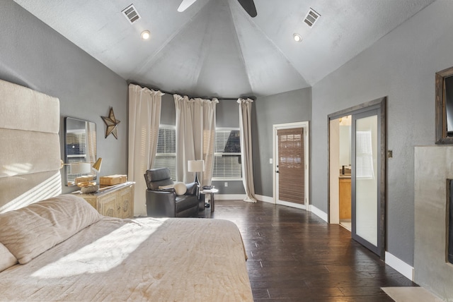 bedroom featuring visible vents, dark wood-type flooring, lofted ceiling, a fireplace, and baseboards