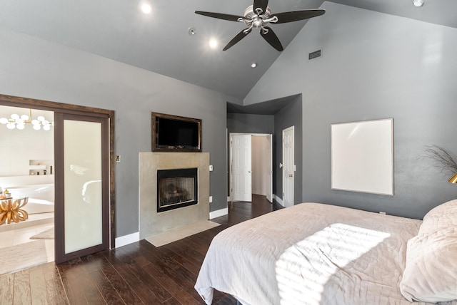 bedroom featuring wood finished floors, baseboards, visible vents, high vaulted ceiling, and a fireplace