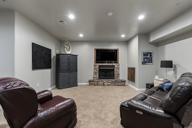 carpeted living area featuring visible vents, recessed lighting, a stone fireplace, and baseboards