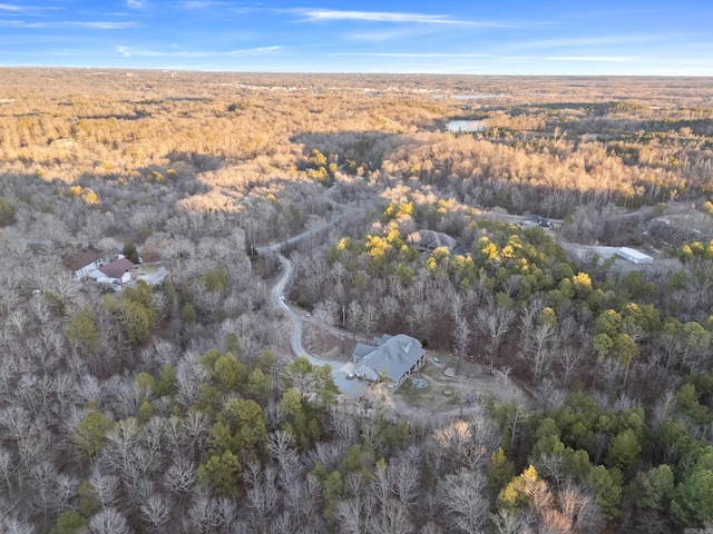 birds eye view of property featuring a view of trees