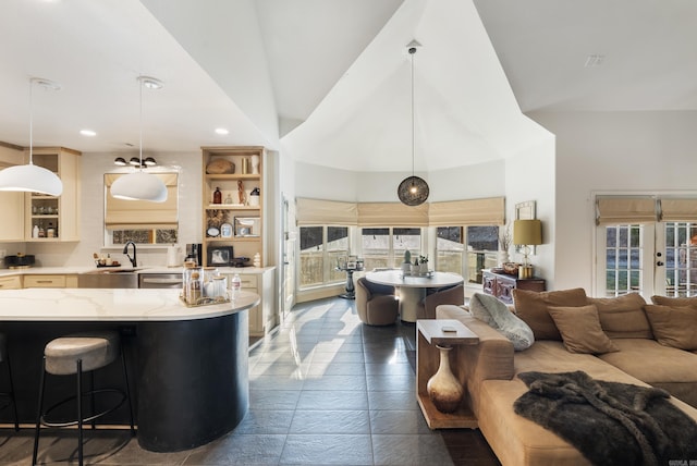 living area with a wealth of natural light, recessed lighting, french doors, and high vaulted ceiling