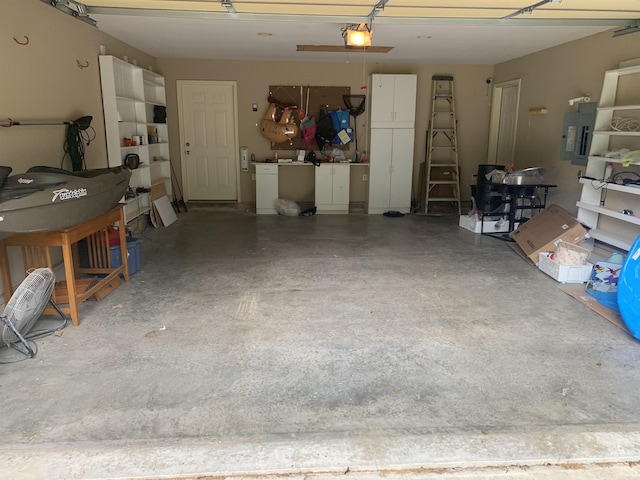 garage featuring electric panel and a garage door opener