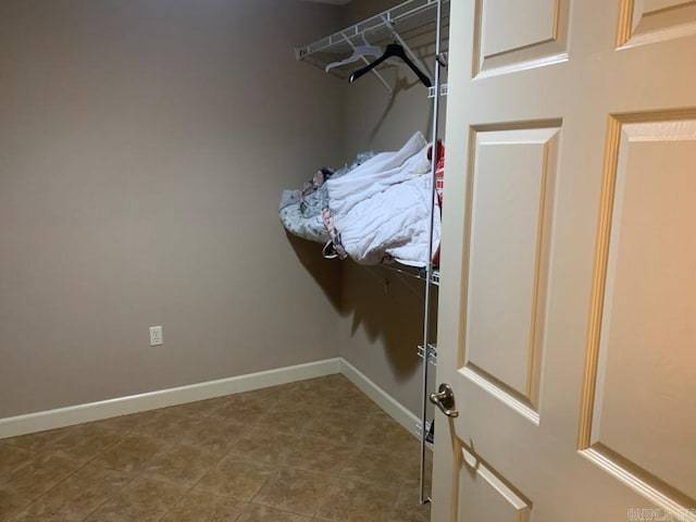 spacious closet featuring tile patterned flooring