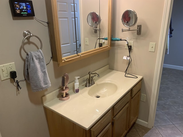 bathroom featuring vanity, tile patterned floors, and baseboards