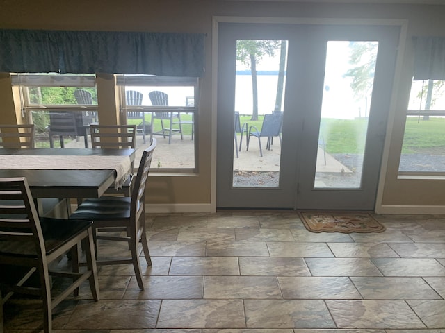 dining area with stone finish floor and baseboards