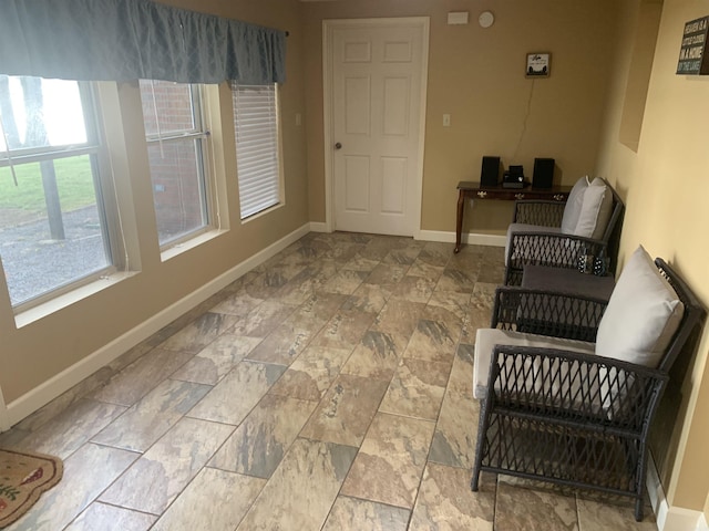 living area featuring baseboards